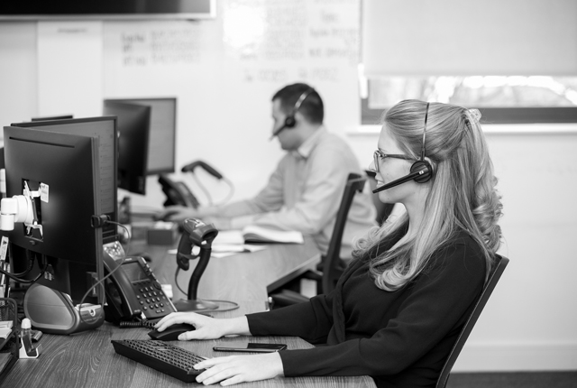 Reliable business phone systems expert talking on a telephone headset