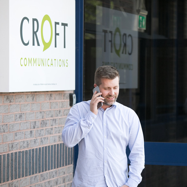 Business telecoms expert talking on a mobile phone.