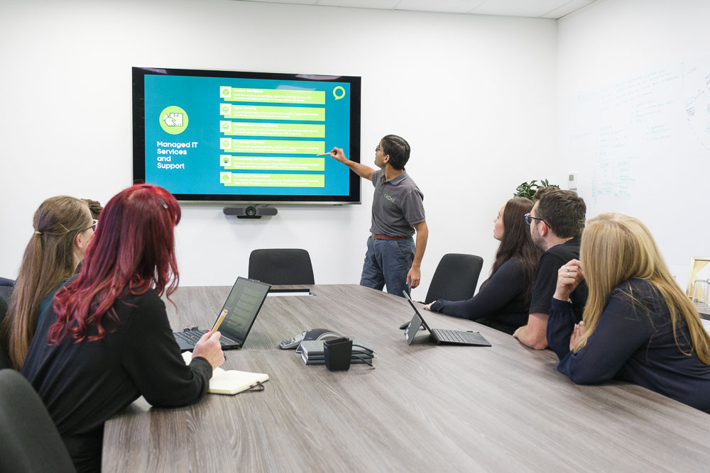 Leased lines expert talking in a meeting at a digital screen