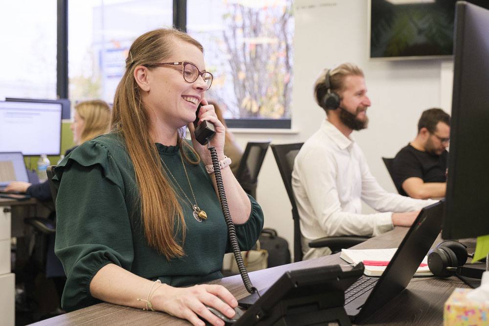 SoGEA expert talking on the phone while sitting at a desktop computer