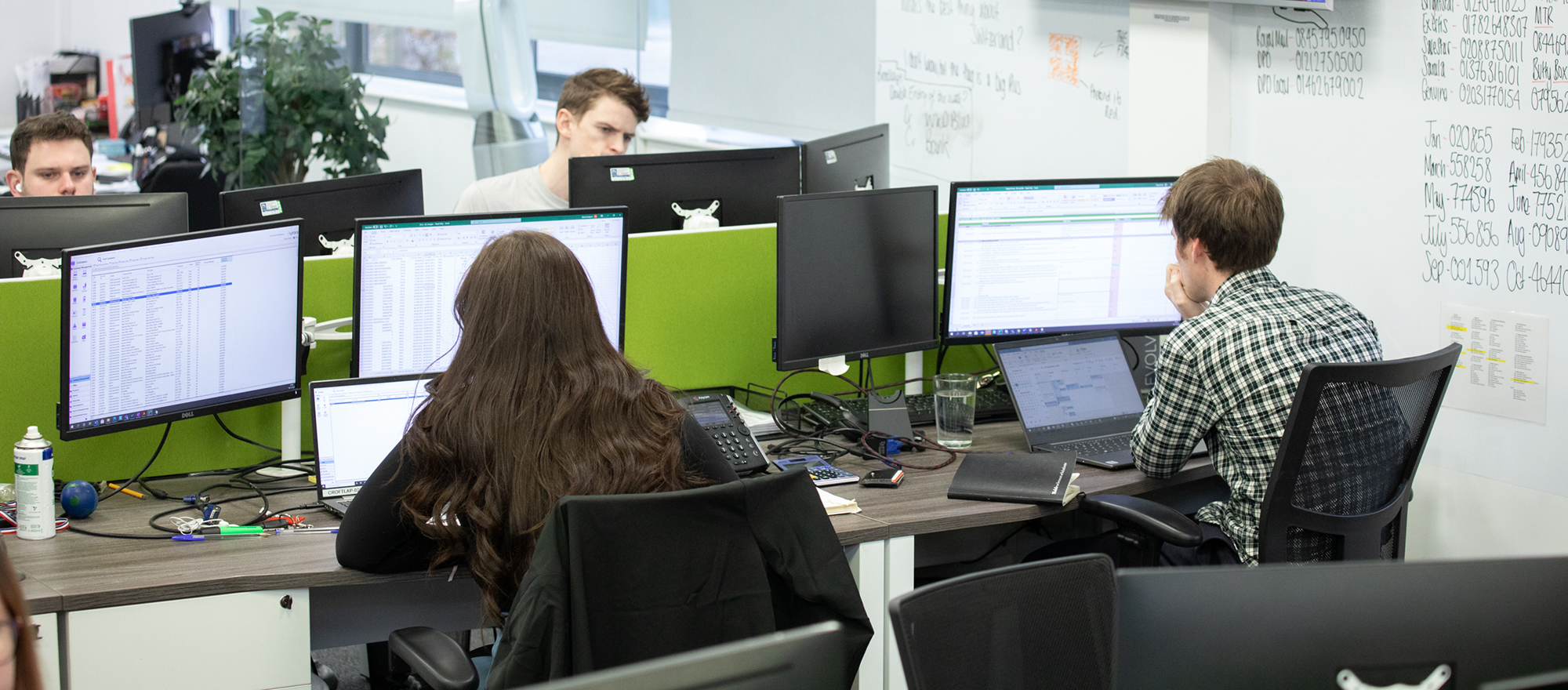 Endpoint detection and response experts working in an open plan office on laptops