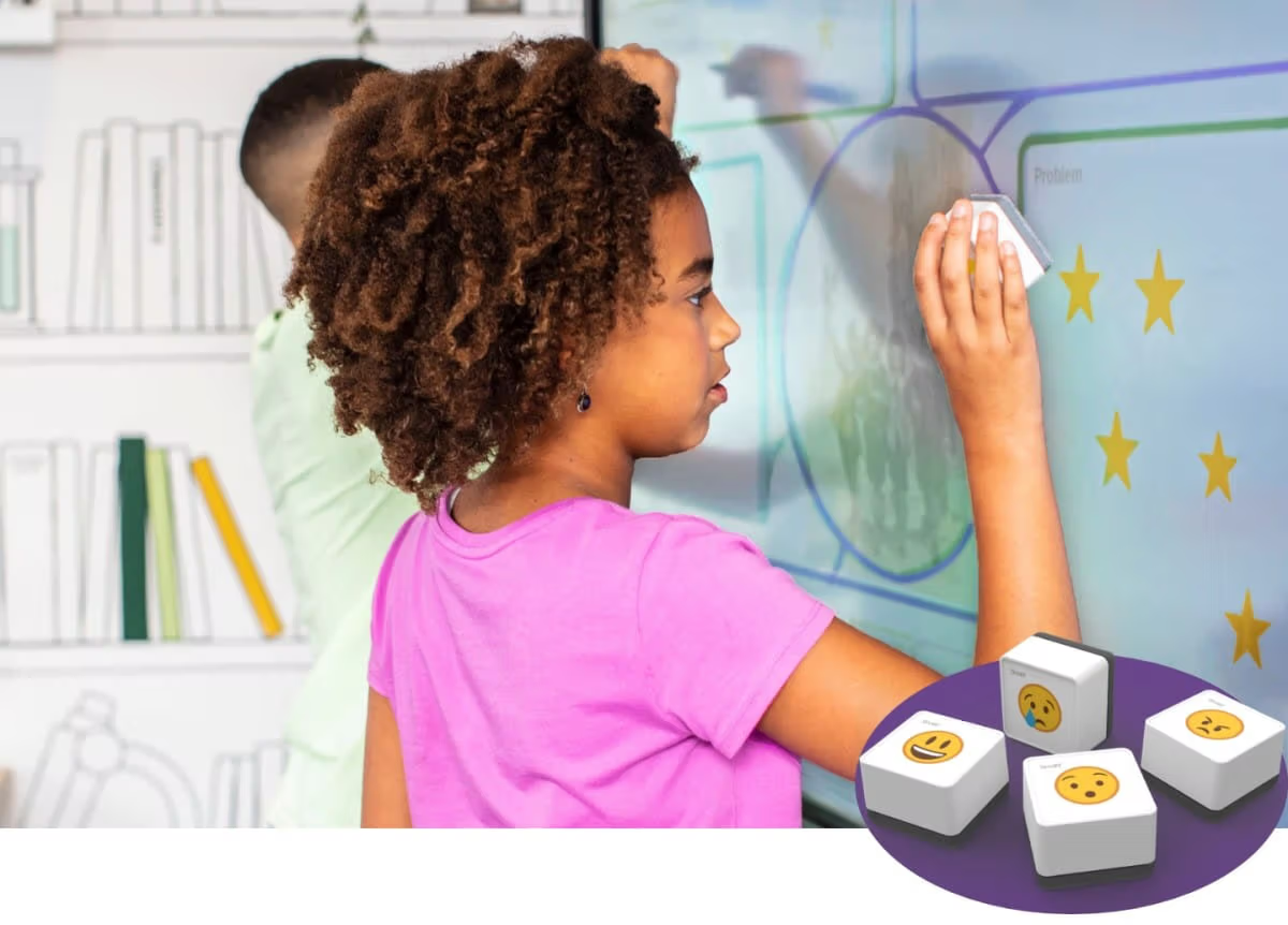 Young student in a pink t-shirt using a interactive display.
