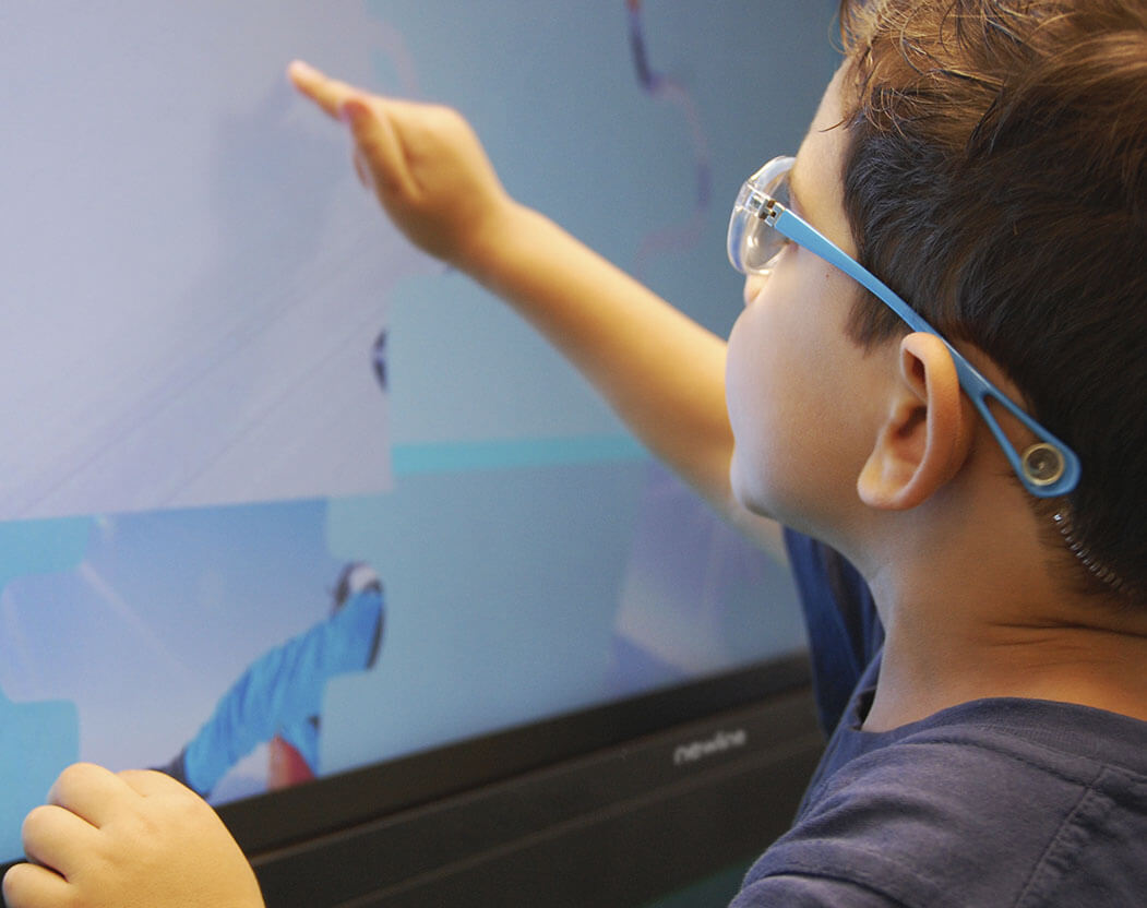 Interactive displays supporting a young child to learn in the classroom.